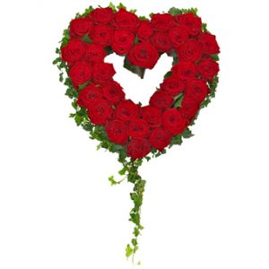 Sorgdekoration med röda rosor och murgröna, format som ett fint hjärta. Murgrönan ramar in det fina rosenhjärtat.