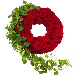 Begravningskrans fylld med röda rosor, ackompanjerade av en fin sträng av murgröna. Kransen finns att beställa hos Euroflorist, en av våra största blomsterförmedlingar på nätet.